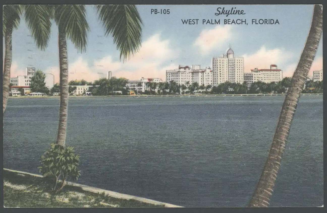 Coloured linen postcard titled 'Skyline, West Palm Beach, Florida' (card PB-105): leaning coconut palms frame a calm blue lake, with a low row of white and cream mid-century hotels and buildings, including one tall tower, along the far shore under a pastel sky.